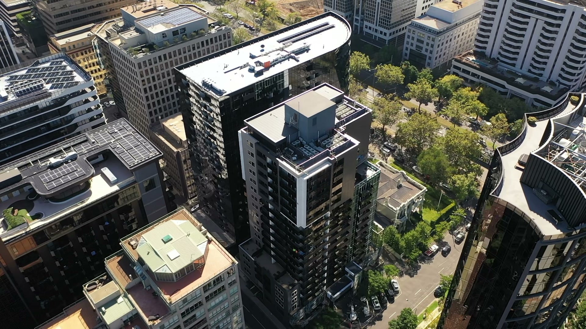 Grand aerial view of a finished, compliant tower beside St Kilda Road parkland