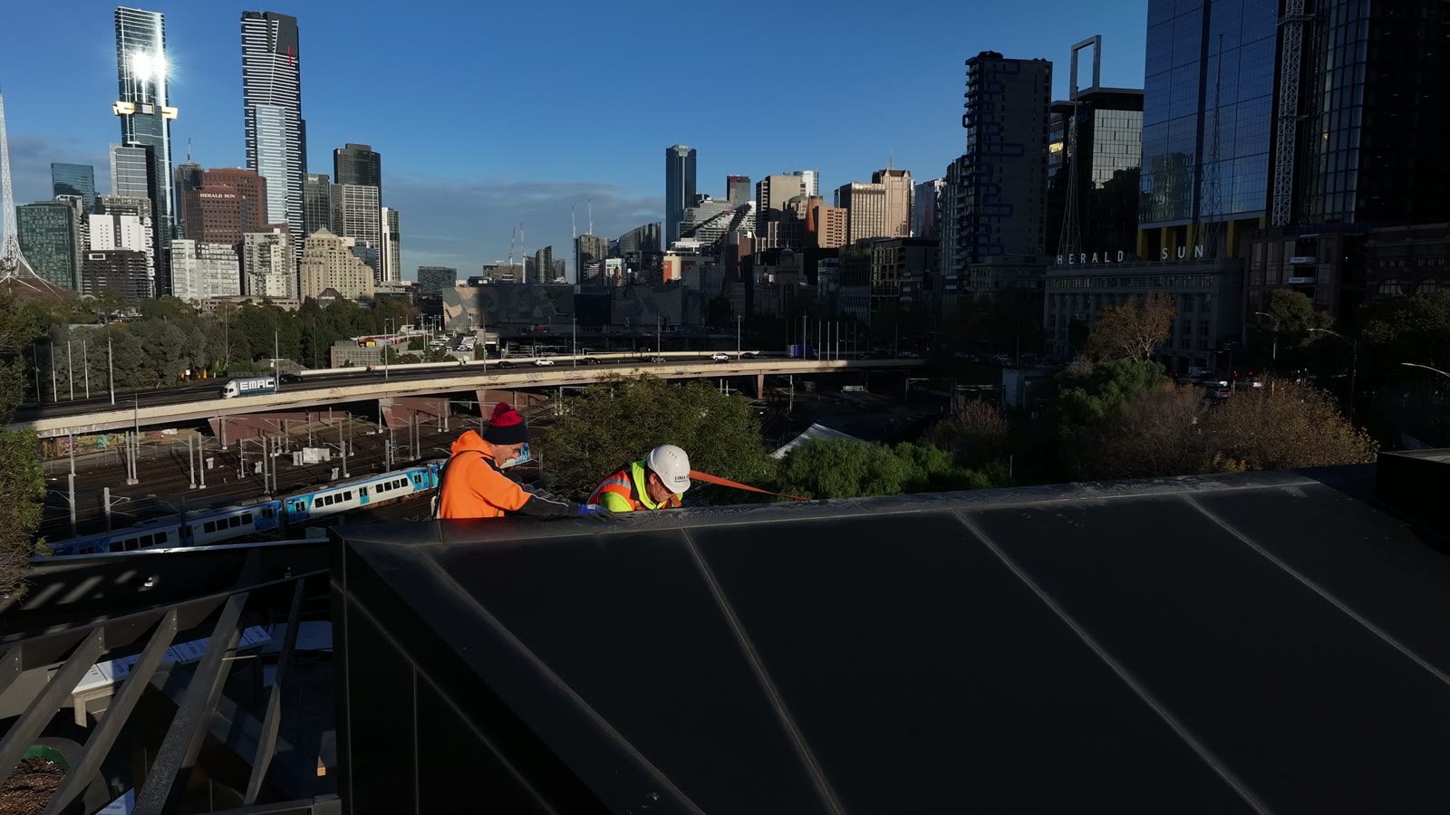 Wellington Parade, East Melbourne — façade remediation on an occupied residential tower with the Melbourne CBD skyline behind